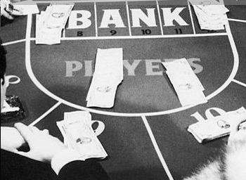 baccarat table in black and white with dollar bills on it