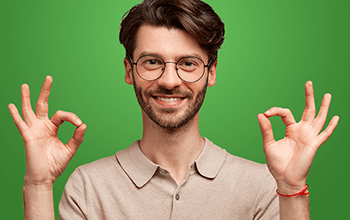 male in glasses holding up both hands