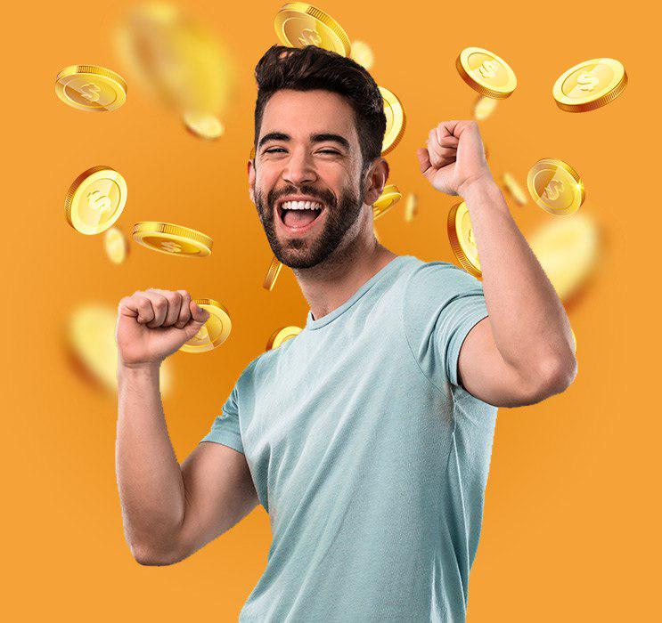 Young bearded male cheering with gold coins falling in background